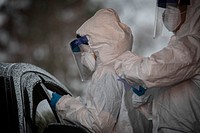 Medical staff collect samples from a patient at a COVID-19 Community-Based Testing Site at the PNC Bank Arts Center in Holmdel, N.J., March 23, 2020.