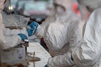 Medical technicians process specimens at a COVID-19 Community-Based Testing Site. Original public domain image from Flickr