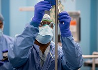 Man prepares the operating room prior to a surgery aboard the hospital ship USNS Mercy (T-AH 19). (U.S. Navy photo by Mass Communication Specialist 2nd Class Ryan M. Breeden). Original public domain image from Flickr