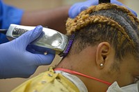 Personnel Specialist 3rd Class receives a haircut aboard the hospital ship USNS Mercy (T-AH 19). (U.S. Navy photo by Mass Communication Specialist Seaman Luke Cunningham). Original public domain image from Flickr