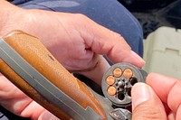 Part of Integrated Wildlife Damage Management (IWDM), U.S. Department of Agriculture (USDA) Animal and Plant Health Inspection Service (APHIS) Wildlife Services (WS) Airport Wildlife Hazard Management Program Wildlife Biologist Michael Pacheco prepares pistol launcher that will send a two-inch noisemaking rocket into the air, hoping that it will drive an overhead vulture away and disperse its threat to the men and women in the jets taking off from Joint Base San Antonio (JBSA) - Randolph, in San Antonio, TX, on April 21, 2020.