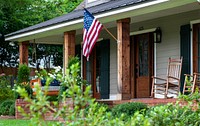 American flag hanging on house facade. Free public domain CC0 photo.