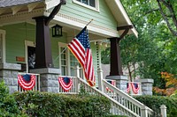 American flag hanging on house facade. Free public domain CC0 photo.