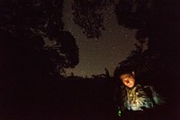 190612-N-TH560-0045 CAMP GONSALVES, Okinawa, Japan (June 12, 2019) Mass Communication Specialist 1st Class Anthony Martinez, from Tampa, Fla., checks camera settings prior to capturing video of a night-time medical casualty exercise during a Jungle Medicine Course at Jungle Warfare Training Center, Okinawa, Japan.