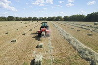 Hay harvest at Ernie Schirmer Farms in Macdona, TX, just outside of San Antonio, TX, on Aug 16, 2020. USDA Photo by Lance Cheung. Original public domain image from Flickr