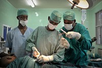 Medical doctors perform a surgical procedure at the Banadir Hospital in Mogadishu, Somalia, on 4 February 2014. AMISOM Photo / Tobin Jones. Original public domain image from Flickr