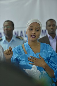 A Somali woman sings the Somali national anthem during a function to celebrate female peacekeepers on 6 March 2014 in Mogadishu, Somalia. AU-UN IST Photo. Original public domain image from Flickr