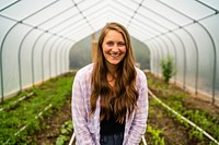 Ellie Fleshman in rows of tomatoes, corn, asparagus, watermelon and cucumbers she and husband Reid planted in newly installed high tunnel.