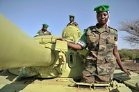 Tank driver, Lance Corporal Mudondo Zabina, tank commander, Corporal Kyomuhendo Ballet and tank gunner Lance Corporal Otuga Maureen of the Uganda Peoples Defence Forces on their tank.