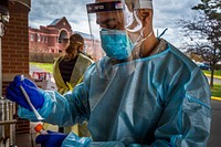 A U.S. Air Force Airman with the 108th Wing, New Jersey Air National Guard, holds nasal swab and vial during COVID-19 RT-PCR testing at the New Jersey Veterans Memorial Home at Vineland, Vineland N.J., Dec. 1, 2020. The test detects the live active virus for SARS-CoV-2, the virus that causes COVID-19. There are currently 26 New Jersey National Guard Soldiers and Airmen assisting at New Jersey’s three Veterans Memorial Homes, 10 are at Vineland. (New Jersey National Guard photo by Mark C. Olsen). Original public domain image from Flickr