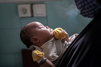 USAID Jalin supports MNH during COVID-19, Ms Turmini hold her baby before got vaccine in Midwife kussudiati private clinic on Monday , November 16, 2020 at Tangerang, Indonesia. (Oscar Siagian/ USAID-JALIN). Original public domain image from Flickr