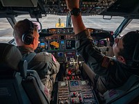 RAF LOSSIEMOUTH, Scotland (Dec. 19, 2020) Cmdr. Joseph Snyder, executive officer of the "Grey Knights" of Patrol Squadron (VP) 46, left, and Lt. Cmdr. Clayton Hunt start the engines of a P-8A maritime patrol aircraft while Aviation Electronics Technician 3rd Class Laquan Phillips performs the duties of a plane captain, Dec. 19, 2020.