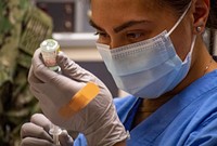 Hospitalman Cierrajaye Santella, assigned to Naval Hospital Bremerton/Navy Medicine Readiness and Training Command (NMRTC) Bremerton, prepares to administer one of the first Moderna COVID-19 vaccines Dec. 23, 2020.