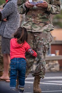 Daughter hugging her U.S. soldier dad. Original public domain image from Flickr