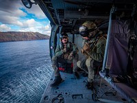 SIGONELLA, Italy (Dec. 12, 2020) Naval Aircrewman (Helicopter) 1st Class Ben Chellew, left, and Naval Aircrewman (Helicopter) 2nd Class Meriah Romo, assigned to the "Ghost Riders" of Helicopter Sea Combat Squadron (HSC) 28, conduct a Search and Rescue exercise onboard an MH-60S Sea Hawk, Dec. 12, 2020.