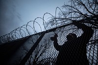 A municipal worker secures c-wire on fencing at a National Guard security post near the Capitol in Washington, D.C., Jan. 16, 2021.