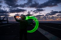 MEDITERRANEAN SEA. Aviation Structural Mechanic Airman Monica Smith, from Wilmington, North Carolina, directs a test of an alert helicopter on the flight deck aboard the Nimitz-class aircraft carrier USS Dwight D. Eisenhower (CVN 69), in the Mediterranean Sea, March 19, 2021.