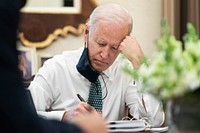 President Joe Biden takes notes during a briefing on the shootings in Atlanta Wednesday, March 17, 2021, in the Oval Office Dining Room of the White House. (Official White House Photo by Adam Schultz). Original public domain image from Flickr