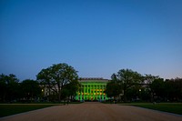 Green lights illuminate the USDA’s Jamie L. Whitten Building in Washington, DC, April 19, 2021 and will remain lit until April 21, 2021.
