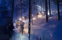 BOHINJSKA BELA, Slovenia -- As night falls, Soldiers with U.S. Army Europe's 172nd Infantry Brigade and their Slovenian Armed Forces instructors use ropes and helmet lights to move up a forested incline at the SAF Military Mountain School here, Dec. 3. (Photo by Richard Bumgardner).