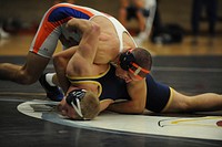 U.S. Coast Guard Academy First Class Cadet Andrew Snyder wrestles during a match at the U.S. Coast Guard Academy Jan. 19, 2011. U.S. Coast Guard photo by Petty Officer 2nd Class Timothy Tamargo. Original public domain image from Flickr