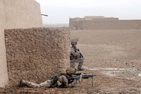 U.S. Marines with 2nd Platoon, Kilo Company, 3rd Battalion, 5th Marine Regiment, Regimental Combat Team (RCT) 2 scan the area outside of a compound during a security/presence patrol in Sangin district, Helmand province, Afghanistan, Feb. 3, 2011.