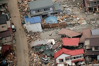 Destroyed houses and debris rest in a Japanese neighborhood.