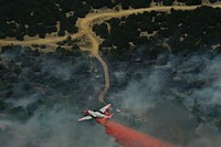 A Minden Air Lockheed SP-2H Neptune tanker drops flame retardant in Texas April 19, 2011, as wildfires burn across the state.