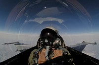 A U.S. Air Force pilot flies an F-16 Fighting Falcon aircraft, assigned to the 18th Aggressor Squadron, 354th Fighter Wing, over the Joint Pacific Alaska Range Complex, near Eielson Air Force Base, during a simulated combat sortie April 18, 2011, as part of Red Flag-Alaska.