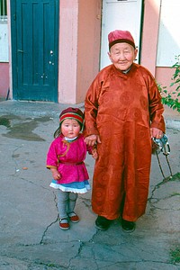 A Mongolian elder and his granddaughter pose for a picture. Original public domain image from Flickr