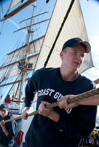 Coast Guard Third Class Cadet Boone Swanberg hauls a line while aboard the Coast Guard Cutter Eagle Wednesday, June 22, 2011, in the North Sea. The Eagle is underway for the 2011 Summer Training Cruise, which commemorates the 75th anniversary of the 295-foot barque. U.S. Coast Guard photo by Petty Officer 1st Class NyxoLyno Cangemi. Original public domain image from Flickr