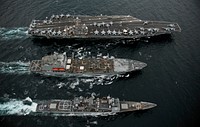 From top, the aircraft carrier USS Abraham Lincoln (CVN 72), the fleet replenishment oiler USNS Guadalupe (T-AO 200) and the guided missile cruiser USS Cape St. George (CG 71) conduct a replenishment at sea in the Pacific Ocean Sept. 26, 2011.