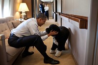 President Barack Obama plays with Bo, the Obama family dog, aboard Air Force One during a flight to Hawaii, Dec. 23, 2011.