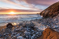 Sunset on the beach shore. Free public domain CC0 photo.