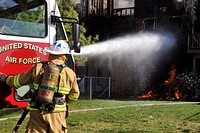 Firefighters from the 11th Civil Engineer Squadron use the bumper turret on an Aircraft Rescue and Firefighting truck to extinguish a house fire at Joint Base Andrews, Md., March 29, 2012.