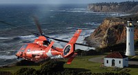 A U.S. Coast Guard MH-65C Dolphin helicopter crew assigned to Air Station Los Angeles conducts a flyover of the Point Vicente Lighthouse as part of the memorial service for Coast Guard Chief Petty Officer Fernando Jorge March 18, 2012, in Los Angeles.