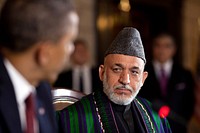 Afghan President Hamid Karzai listens as President Barack Obama delivers remarks during the strategic partnership agreement signing ceremony at the Presidential Palace in Kabul, Afghanistan, May 1, 2012.
