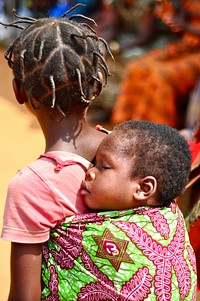 Ghana child sleeps at health event. (USAID/Kasia McCormick) 2012. Original public domain image from Flickr