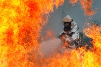 A firefighter assigned to the 51st Civil Engineer Squadron extinguishes a fire during a simulated U.S. Air Force C-130 Hercules plane crash during operational readiness exercise Beverly Midnight 12-03 at Osan Air Base, Republic of Korea, July 23, 2012.