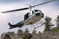 Mountain West Helicopter pilot Randy Mason takes off in a Bell UH-1H (2-blade rotor) after being refueled at the Seaman Reservoir spillway, near Fort Collins, Colo., on Friday, July 20, 2012.