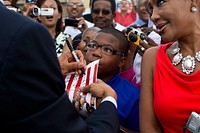 President Barack Obama signs a photograph as he greets people on the tarmac upon arrival at Louis Armstrong International Airport in New Orleans, La., July 25, 2012.