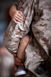 Ohana Hug. Sgt. Jacob Shepherd, a wireman with the 3rd Marine Regiment Embedded Training Team and a 26-year-old native of Bucyrus, Ohio, holds his 1-year-old son closely after returning to Marine Corps Base Hawaii from a seven-month deployment to Afghanistan.