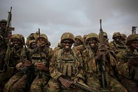 Troops from the Kenyan Contingent of the African Union Mission in Somalia (AMISOM) sit on the back of a flat-bed military truck as they begin an advance on the Somali port city of Kismayo.