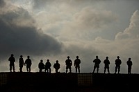 U.S. Soldiers with Charlie Company, 1st Battalion, 21st Infantry Regiment, 2nd Stryker Brigade Combat Team, 25th Infantry Division relax before attending an after-action review of a live-fire exercise at the Pohakuloa Training Area, Mauna Loa, Hawaii, Sept. 20, 2012.