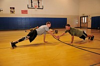 SAN DIEGO (Oct. 19, 2012) &ndash; Army Spc. Chris LaFontaine, left, assigned to Naval Medical Center San Diego&rsquo;s (NMCSD) Army Warrior Transition Unit, and Marine Capt. Eric McElvenny, right, assigned to NMCSD&rsquo;s Wounded Warrior Battalion-West detachment, perform team push-ups during NMCSD&rsquo;s Comprehensive Combat and Complex Casualty Care (C5) program agility clinic.