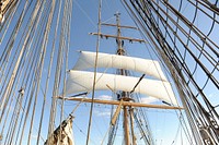 Officer Candidates Aboard Barque EagleATLANTIC OCEAN - Officer candidates from the U.S. Coast Guard Academy climb the Coast Guard Barque Eagle's main mast and yard arms to unfurl the sail Sept. 11, 2012. Officer candidates spend two weeks of their 17-week training aboard America's Tall Ship to further develop their teamwork and leadership skills. (U.S. Coast Guard photo by Petty Officer 1st Class Lauren Jorgensen). Original public domain image from Flickr