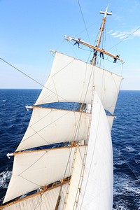 Boat sailing across the ocean. Original public domain image from Flickr