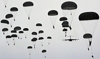 Army paratroopers parachuting in the sky. Original public domain image from Flickr