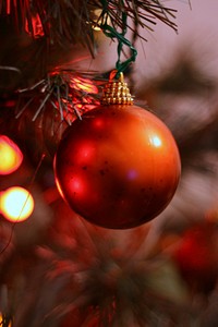 Red christmas ball/bauble/ornament hanging on tree. Original public domain image from Flickr