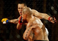 Isaac Moreno punches Henry Liu in the face during their mixed martial arts bout at the Strike Fight event at Eglin Air Force Base, Fla., Dec. 8, 2012.